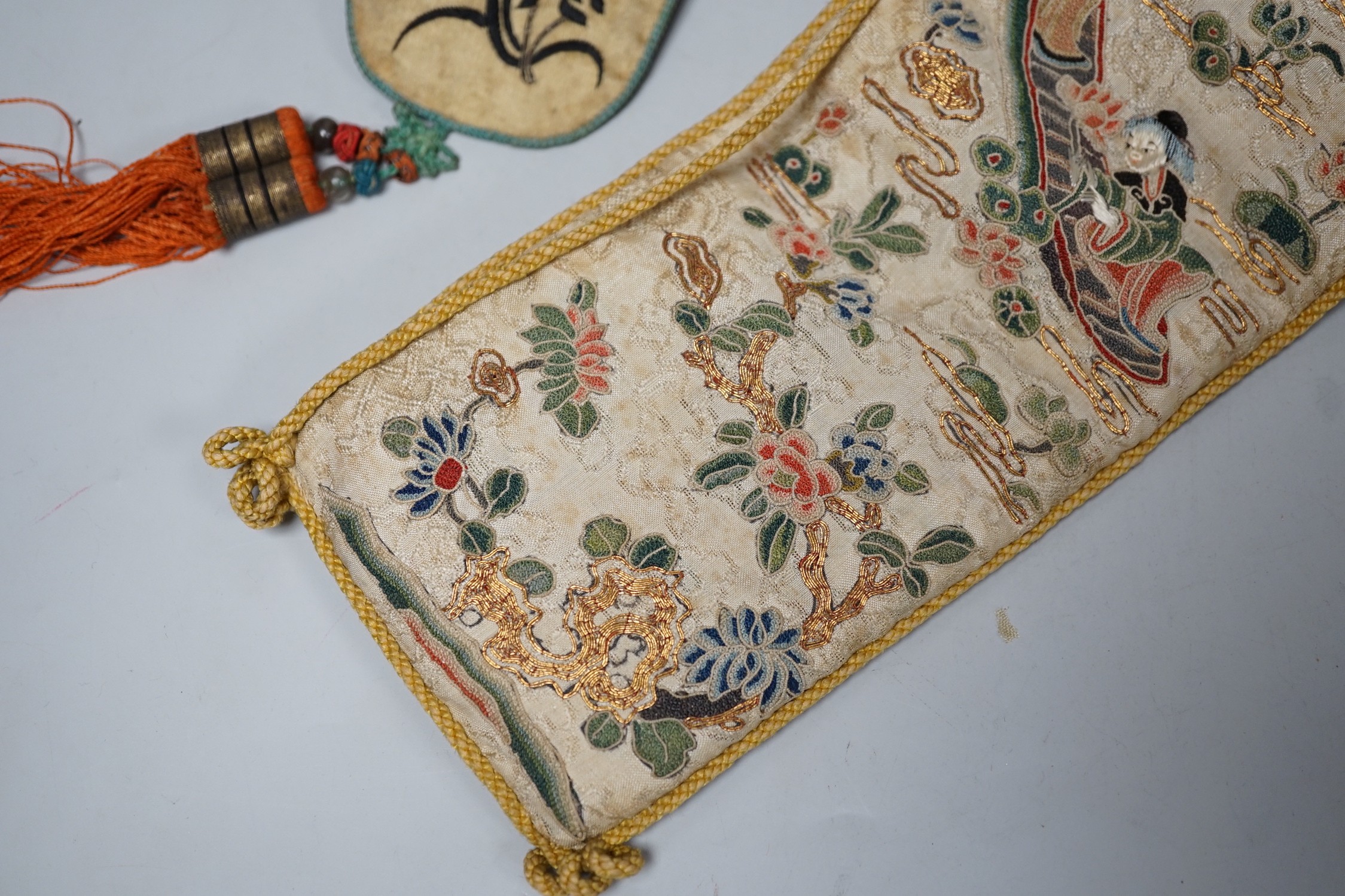 A pair of Chinese 19th century figurative sleeve bands, embroidered with polychrome and metallic threads, stitched in Peking knot and a Chinese embroidered silk purse, with a later panel, (3)